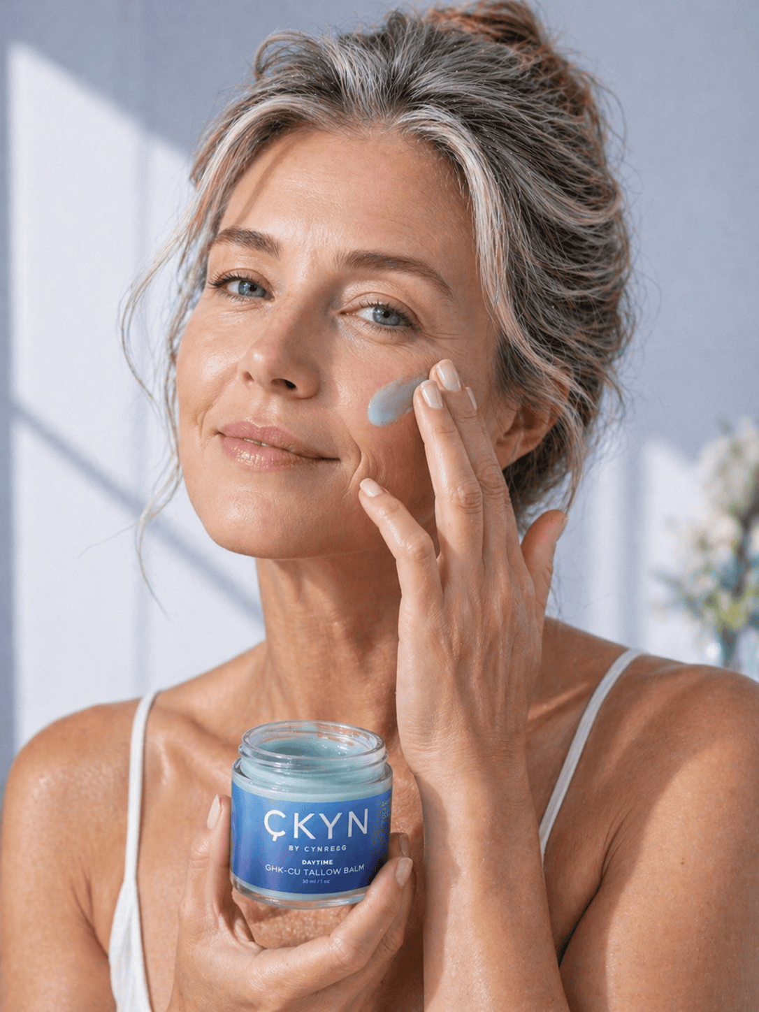 Woman applying CKYN GHK-Cu Tallow Balm